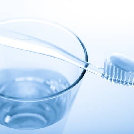 Elegant Toothbrush and Toothpaste Setup in Glass