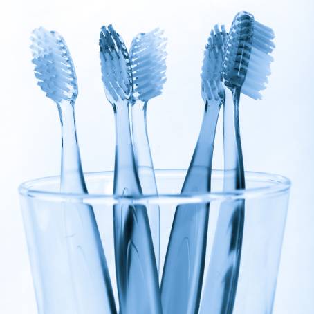 Essential Oral Care Toothbrush and Toothpaste in Glass