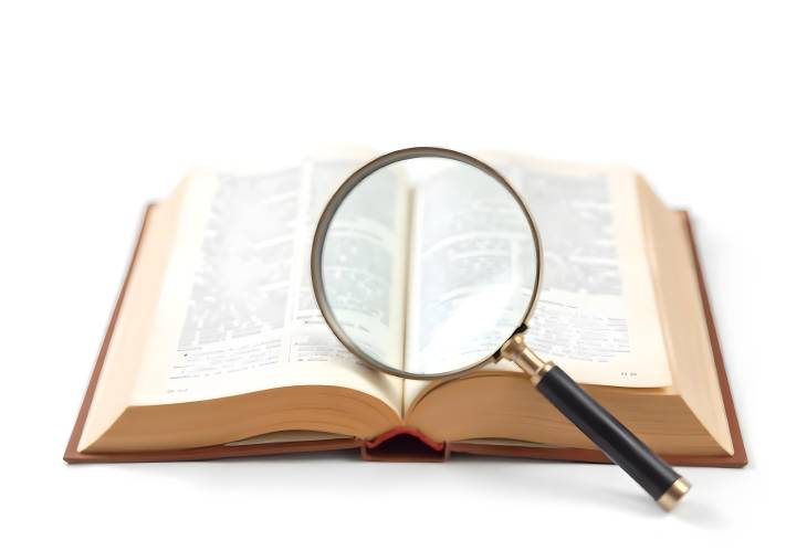 Isolated Book and Magnifying Glass Representing Search for Knowledge