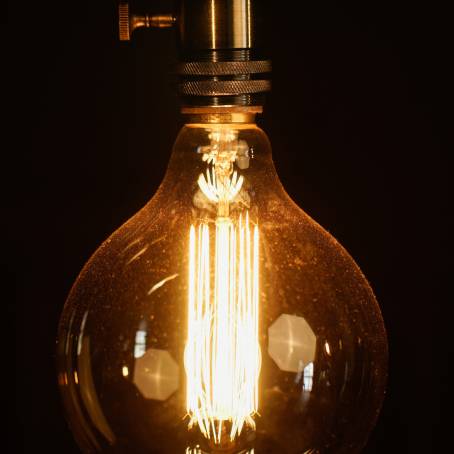 Illuminated Elegance Vintage Bulb CloseUp Over Dark Background