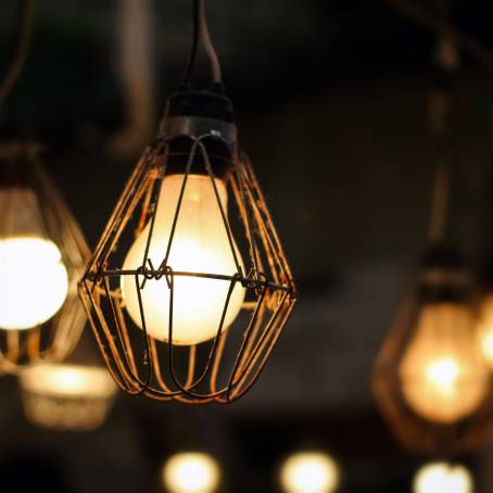 Vintage Glow CloseUp of a Hanging Light Bulb Against Darkness