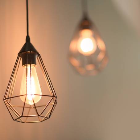 Vintage Light Illuminated Bulb CloseUp Over Dark Canvas