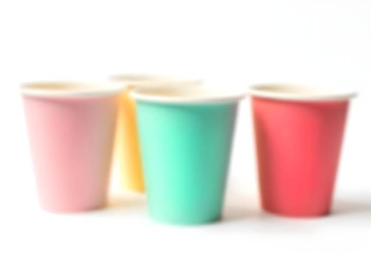 Festive Paper Cups in Various Colors Isolated on White Background